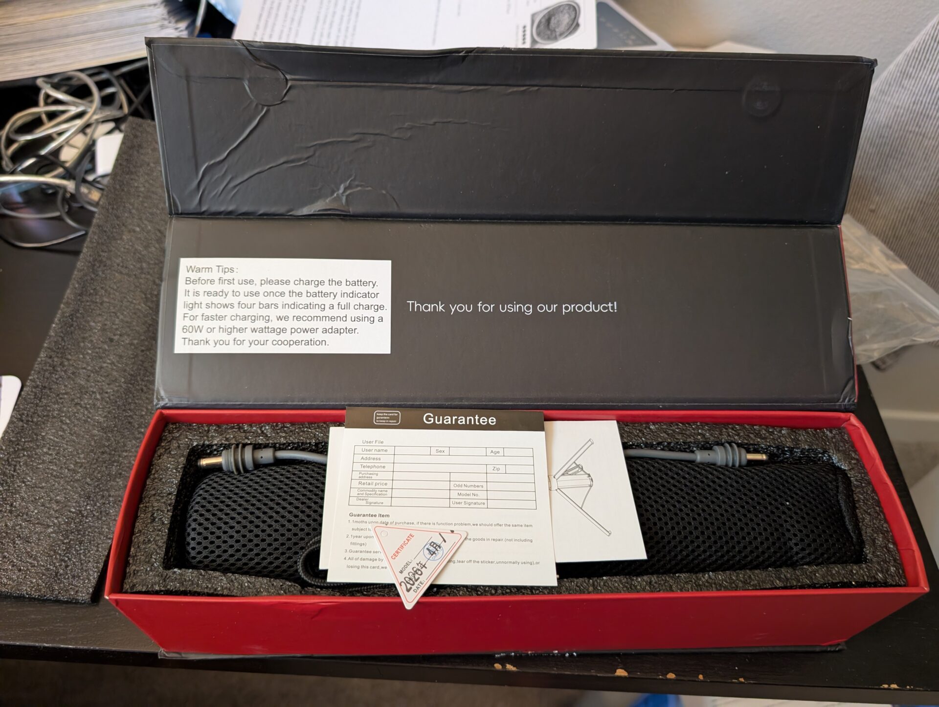 Open box photo of the PeakDo battery kit with included cable and paperwork