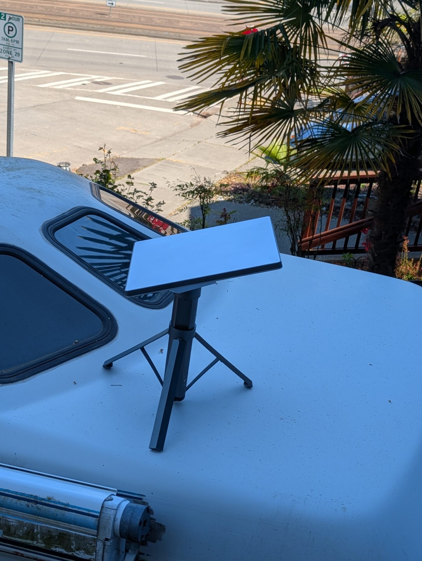 Starlink Mini on the Orbynexa tripod in an outdoor deployment with cable visible